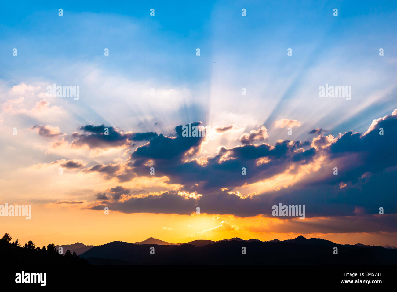 Sunset with sun rays Stock Photo - Alamy