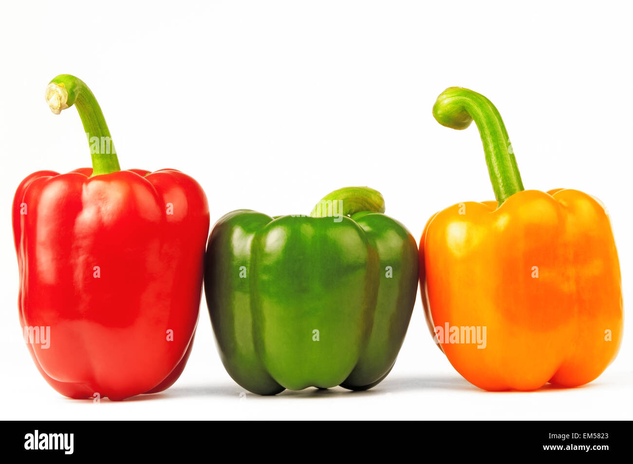 Three multicolored paprikas on the white isolated background Stock