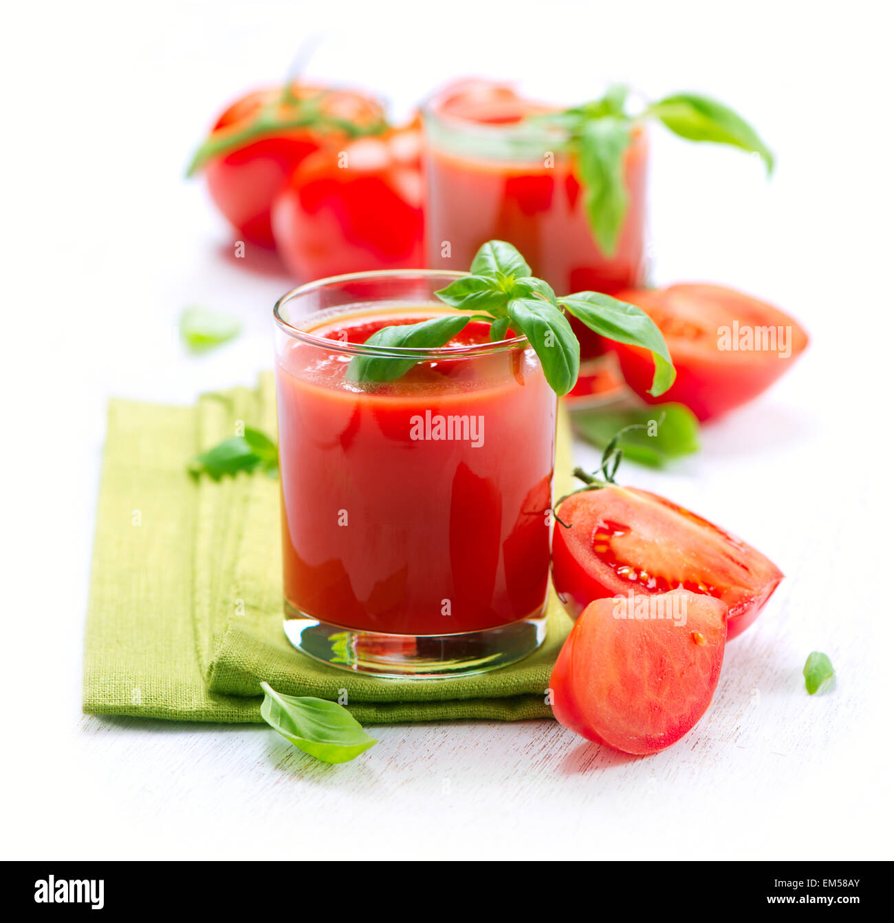 Tomato Juice and Fresh Tomatoes isolated on a White Background Stock Photo