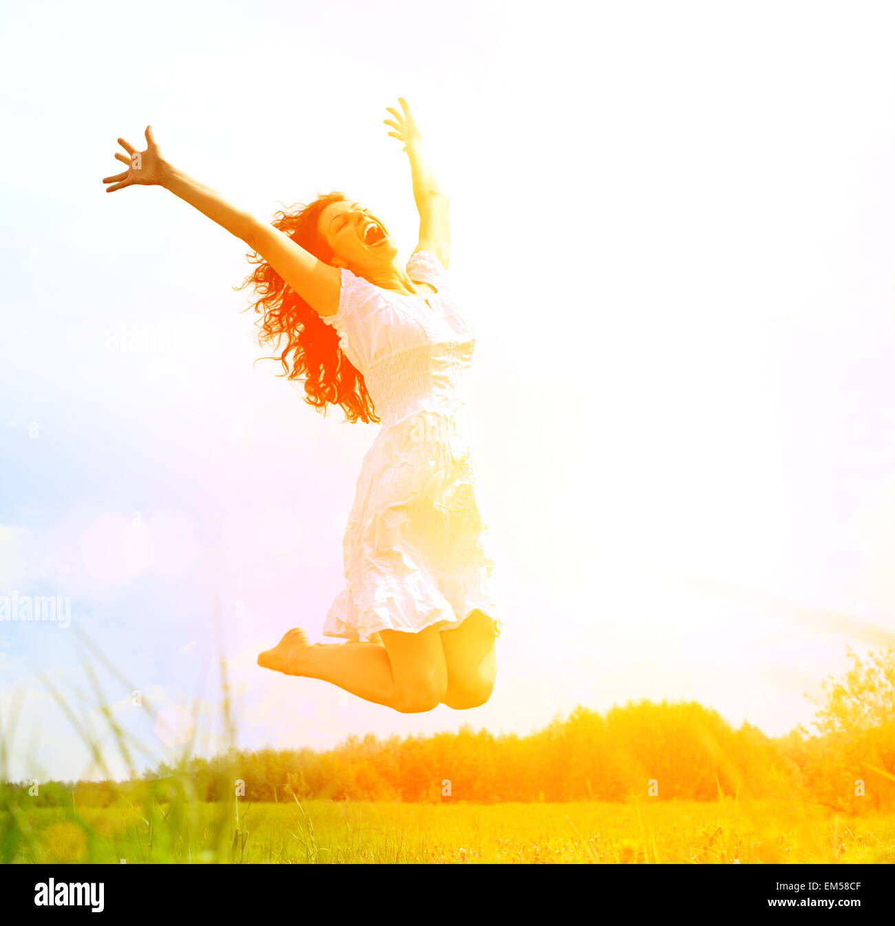 Happy Young Woman Jumping over blue sky. Beauty Girl Having Fun Stock ...