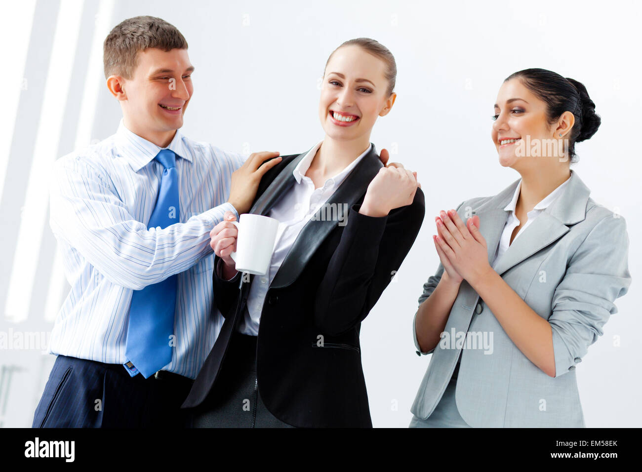 Three young business people laughing Stock Photo - Alamy