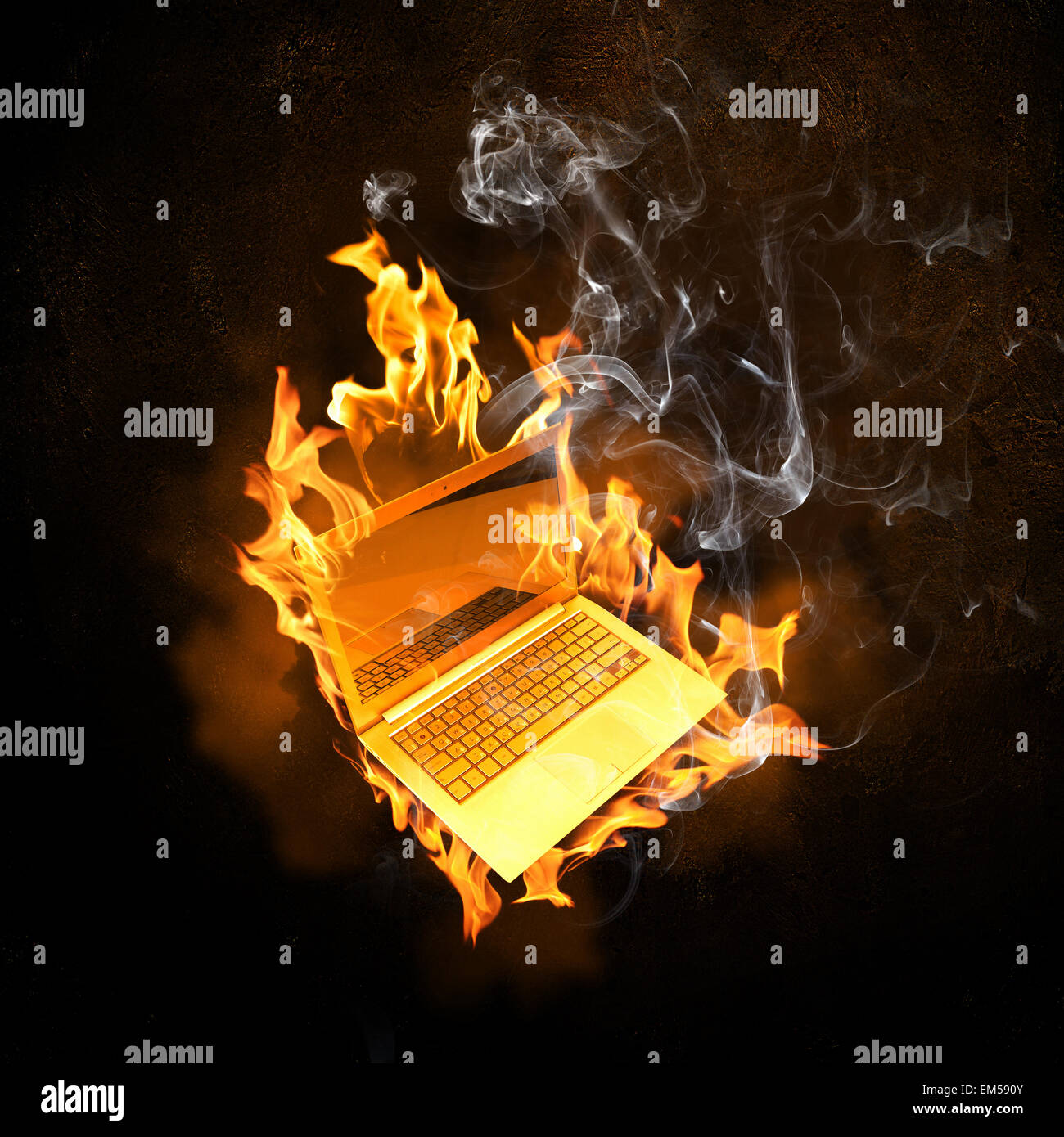 Laptop in fire flames Stock Photo Alamy