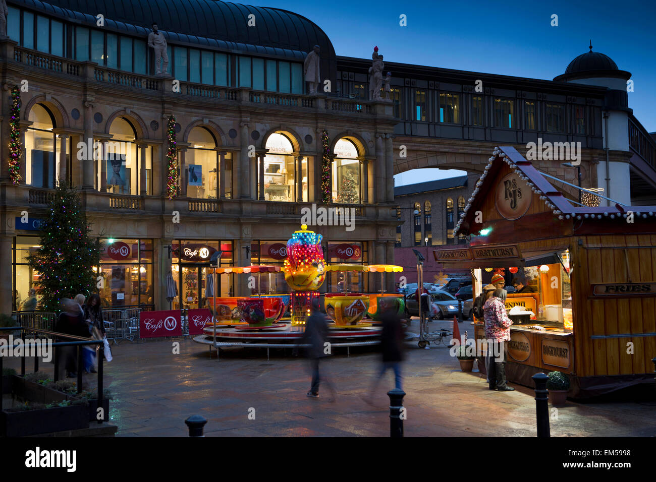 UK, England, Yorkshire, Harrogate at Christmas, roundabout and food stall outside Victoria Centre Stock Photo