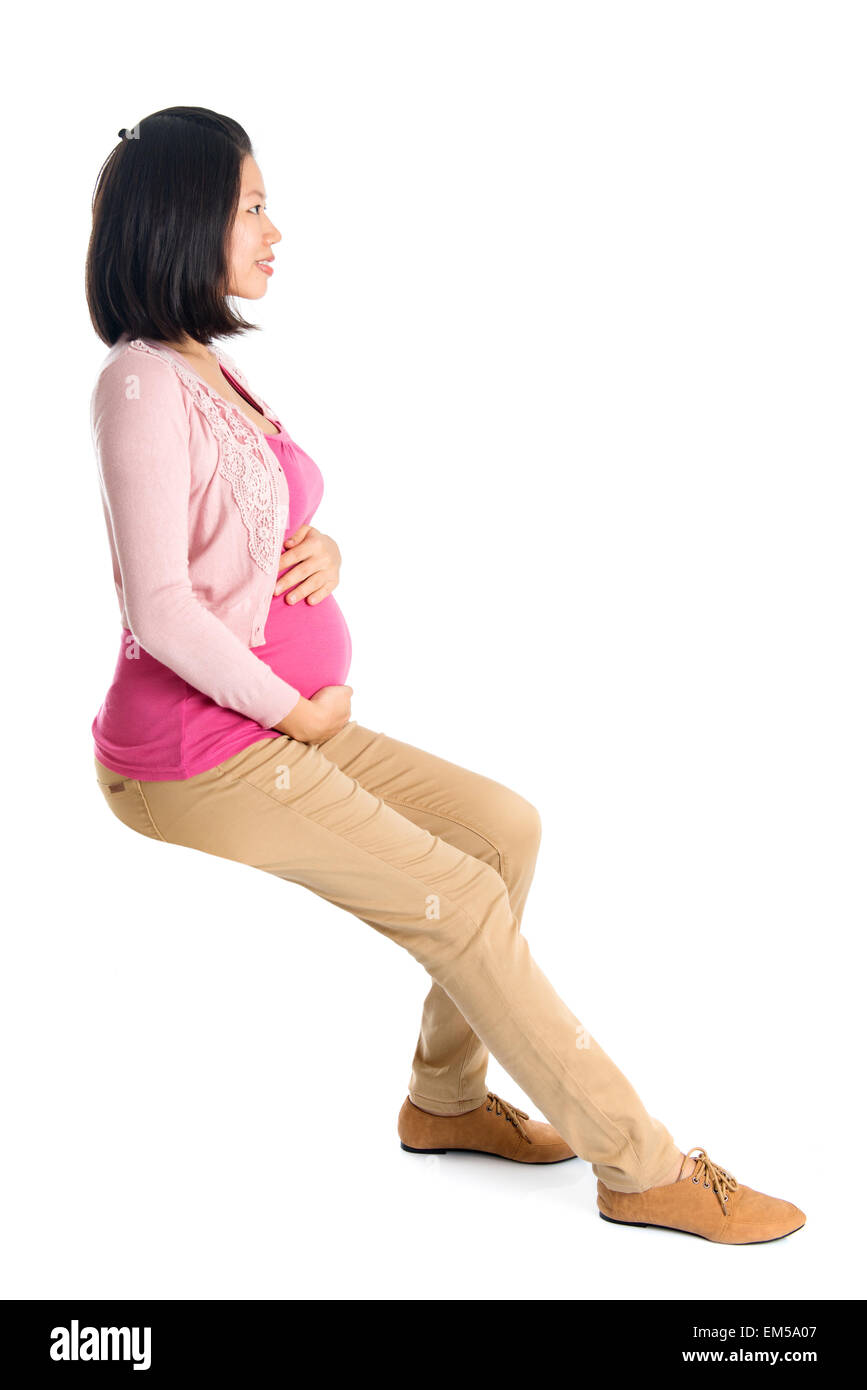 Side view pregnant Asian woman sitting Stock Photo