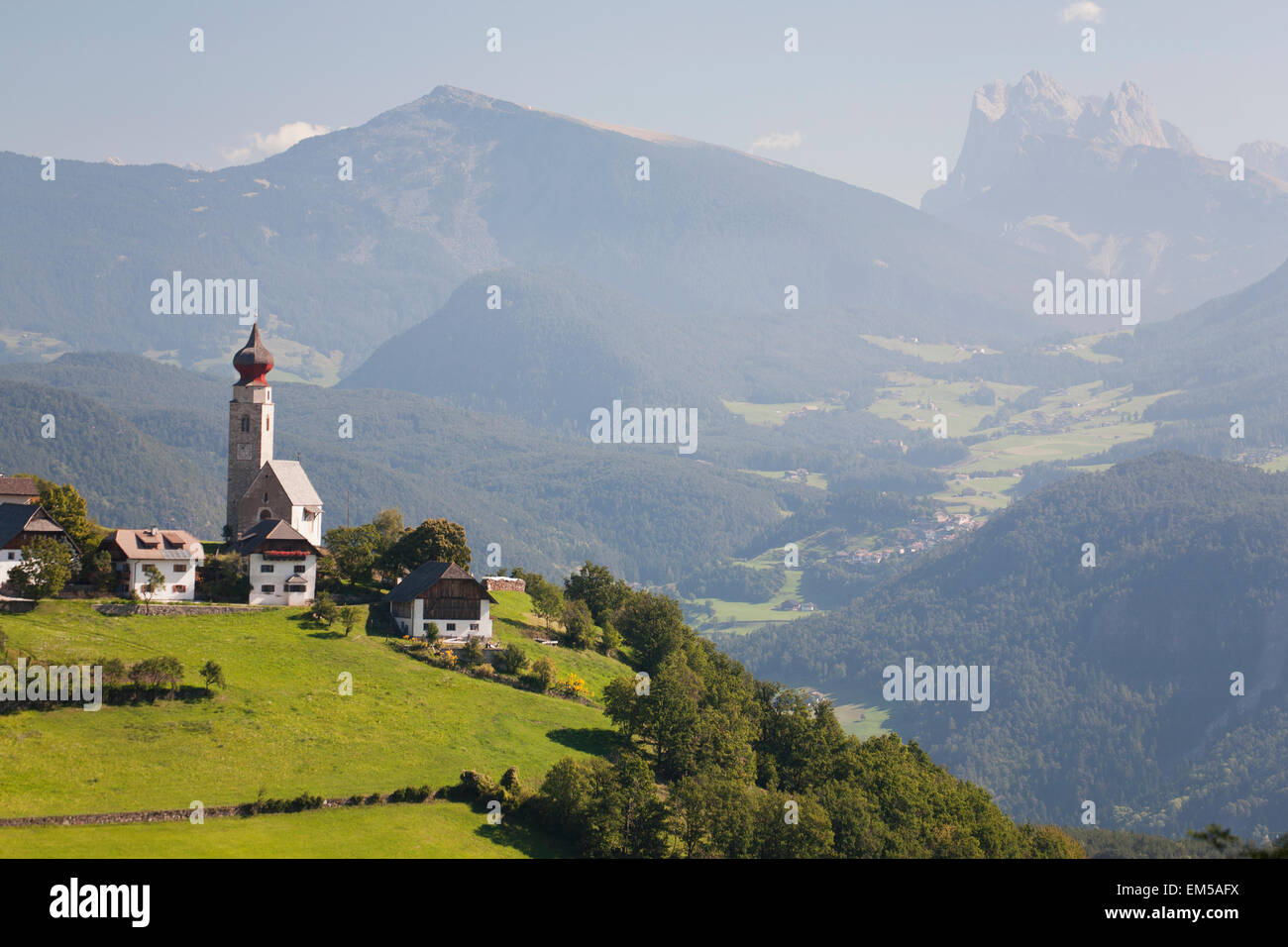 Church with onion dome tower on meadow with mountains and valleys in ...