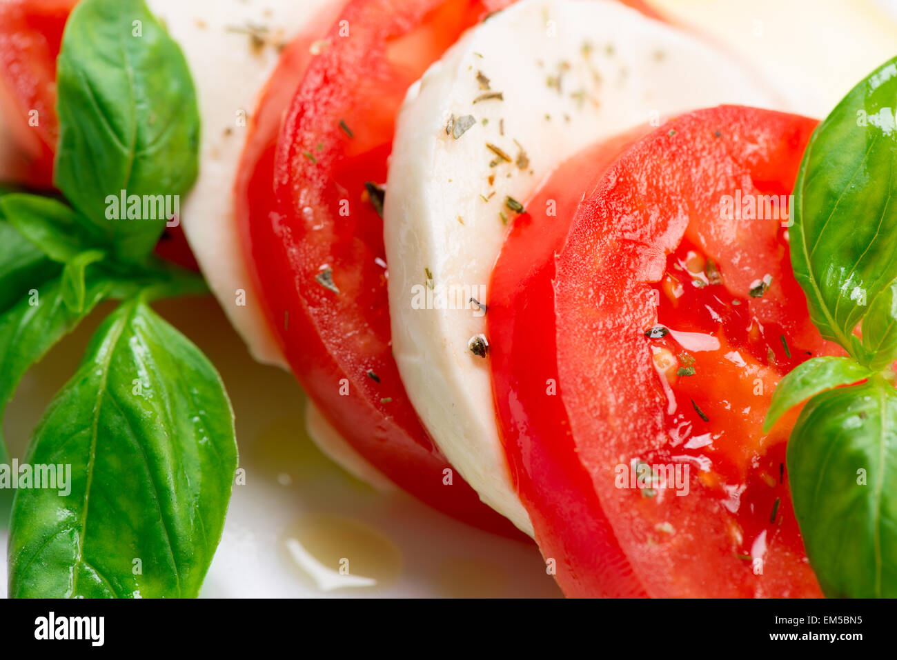 Caprese Salad. Tomato and Mozzarella slices with basil leaves Stock ...