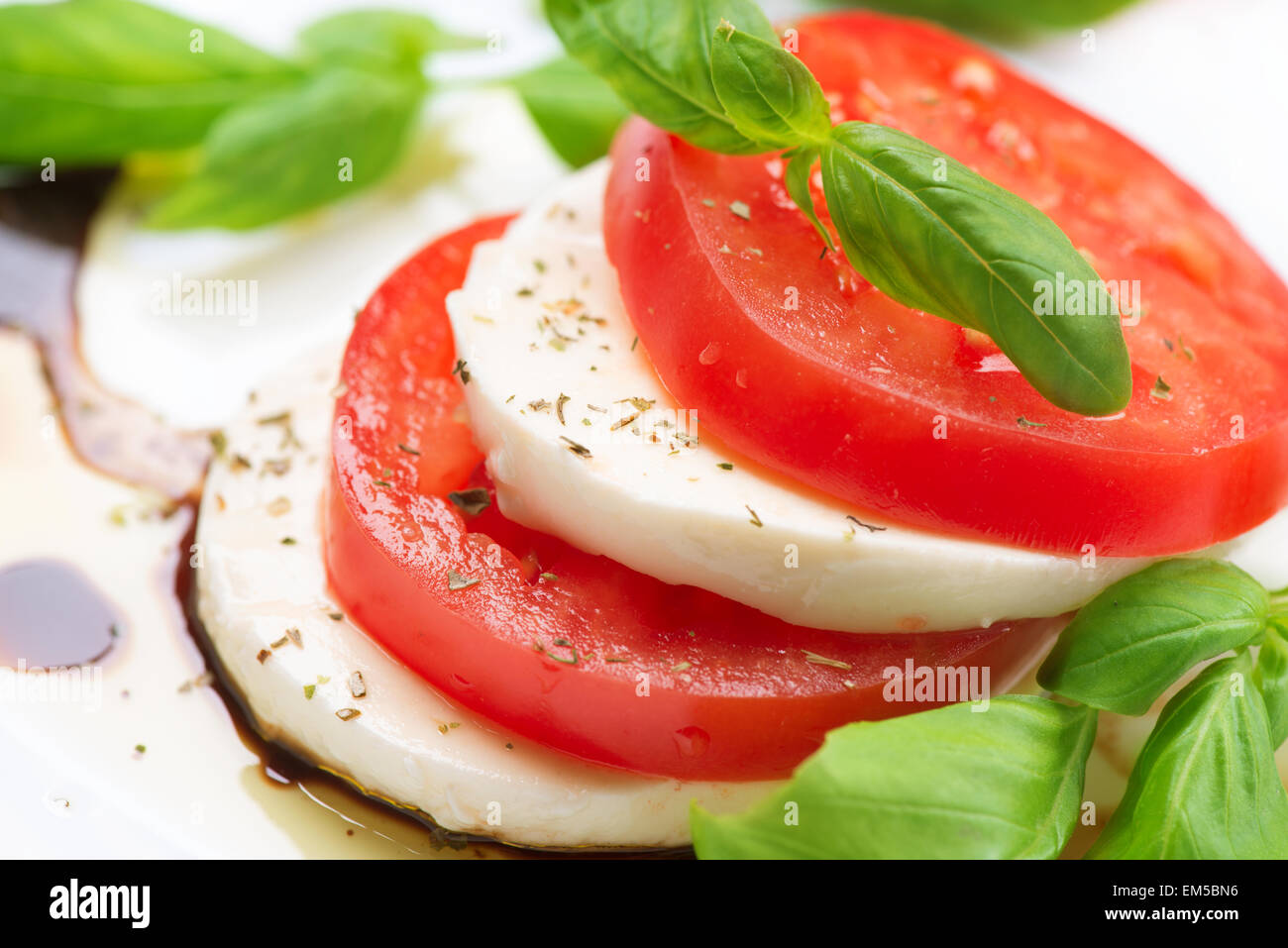 Caprese Salad. Tomato and Mozzarella slices with basil leaves Stock ...