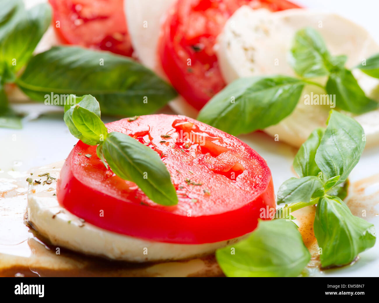 Caprese Salad. Tomato and Mozzarella slices with basil leaves Stock ...