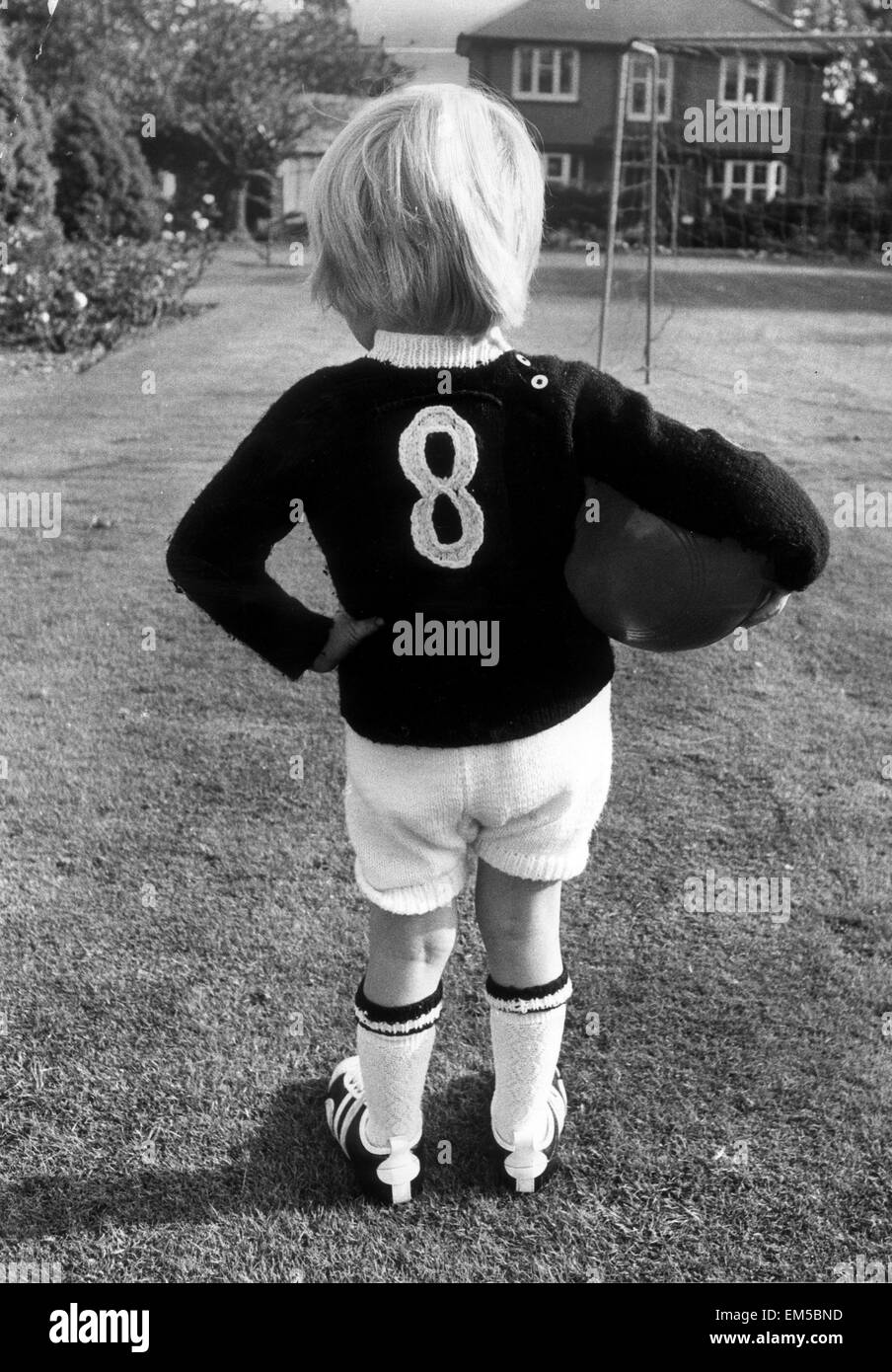 The son of England football international Raich Carter, practicing in the back garden of the family home, wearing a number 8 jersey. 25th October 1972. Stock Photo