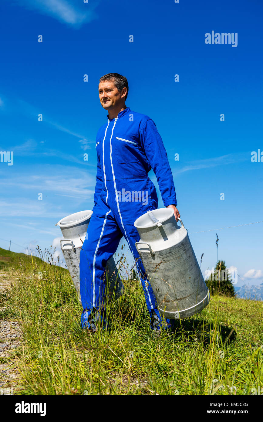 farmer with milk containers Stock Photo