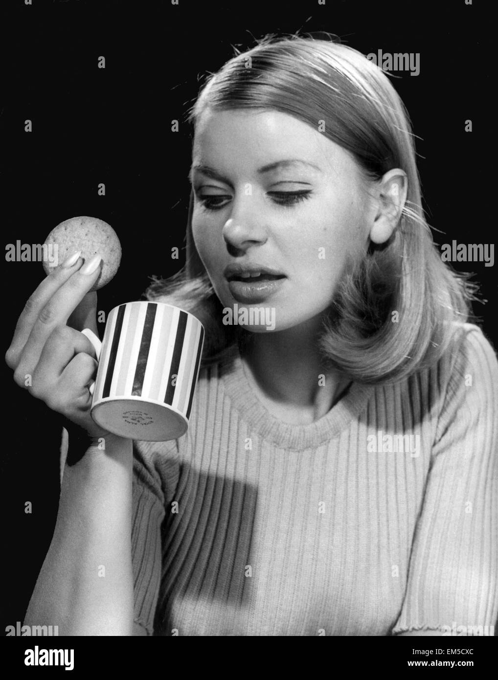 Young office worker having a coffee break at work. 2nd November 1967. Stock Photo