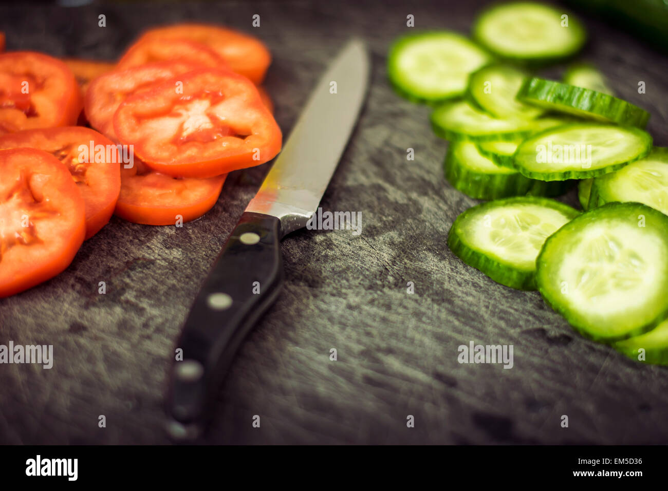 Chopped tomato and cucumber on a chopping board Stock Photo - Alamy