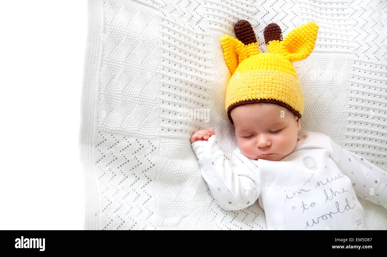 Baby sleeping in giraffe hat Stock Photo