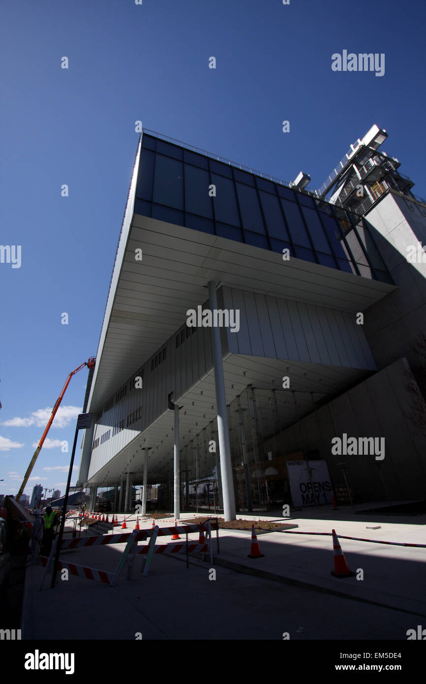 New York, USA. 15th Apr, 2015. Construction workers putting finishing touches on the new Whitney Museum of American Art building at Washington Street and Gansevoort Street, in New York City's Meatpacking District at the end of the High Line.   Designed by architect Renzo Piano, the 200,000-square-foot space will open to the public on May 1st, 2015 Stock Photo