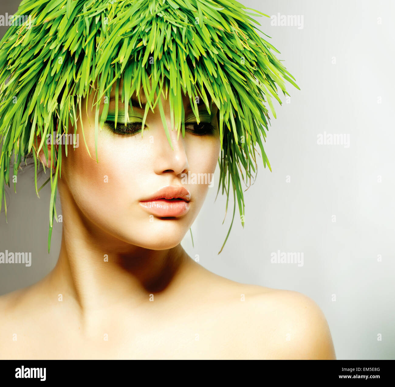 Beauty Spring Woman with Fresh Green Grass Hair Stock Photo