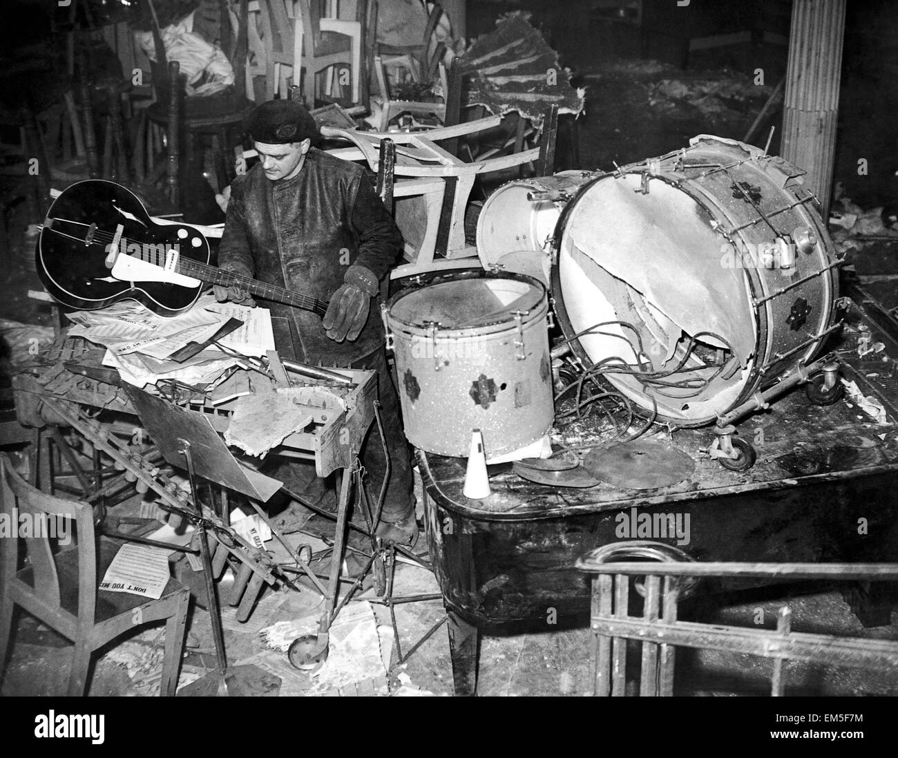 Salvage workers sort through the damaged band instruments at the Cafe de Pais following two 50K landmines which fell through the Rialto roof straight onto the Caf dance floor. Eighty people were killed, including Ken 'Snakehips' Johnston who was performing onstage at the time. March 9th 1941 Stock Photo