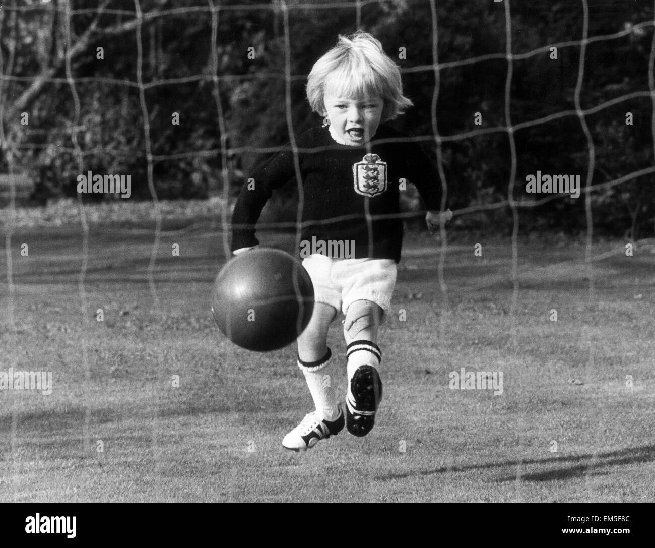 The son of England football international Raich Carter, practicing in the back garden of the family home, wearing an England jersey. 25th October 1972. Stock Photo