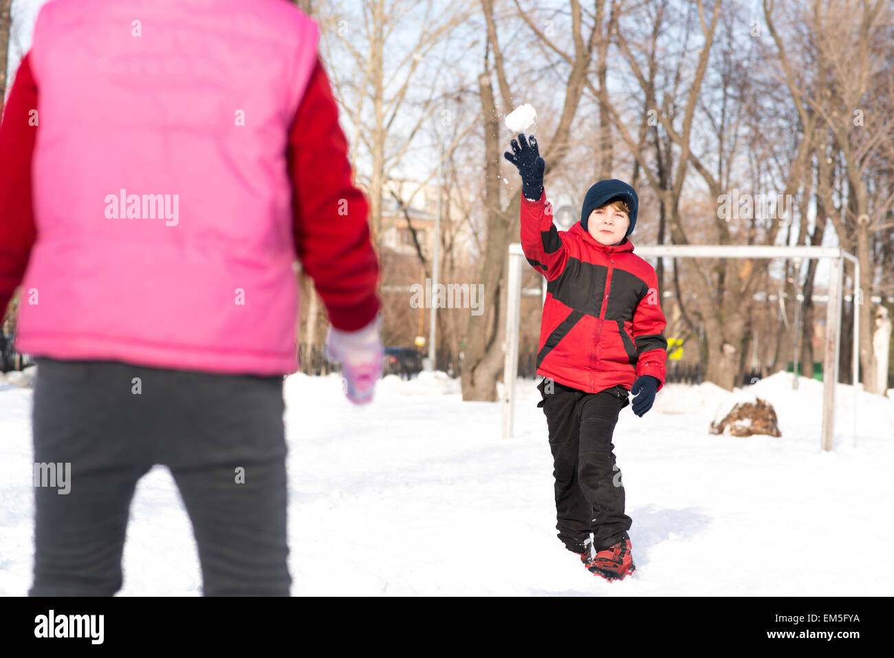Children in Winter Park playing snowballs Stock Photo - Alamy