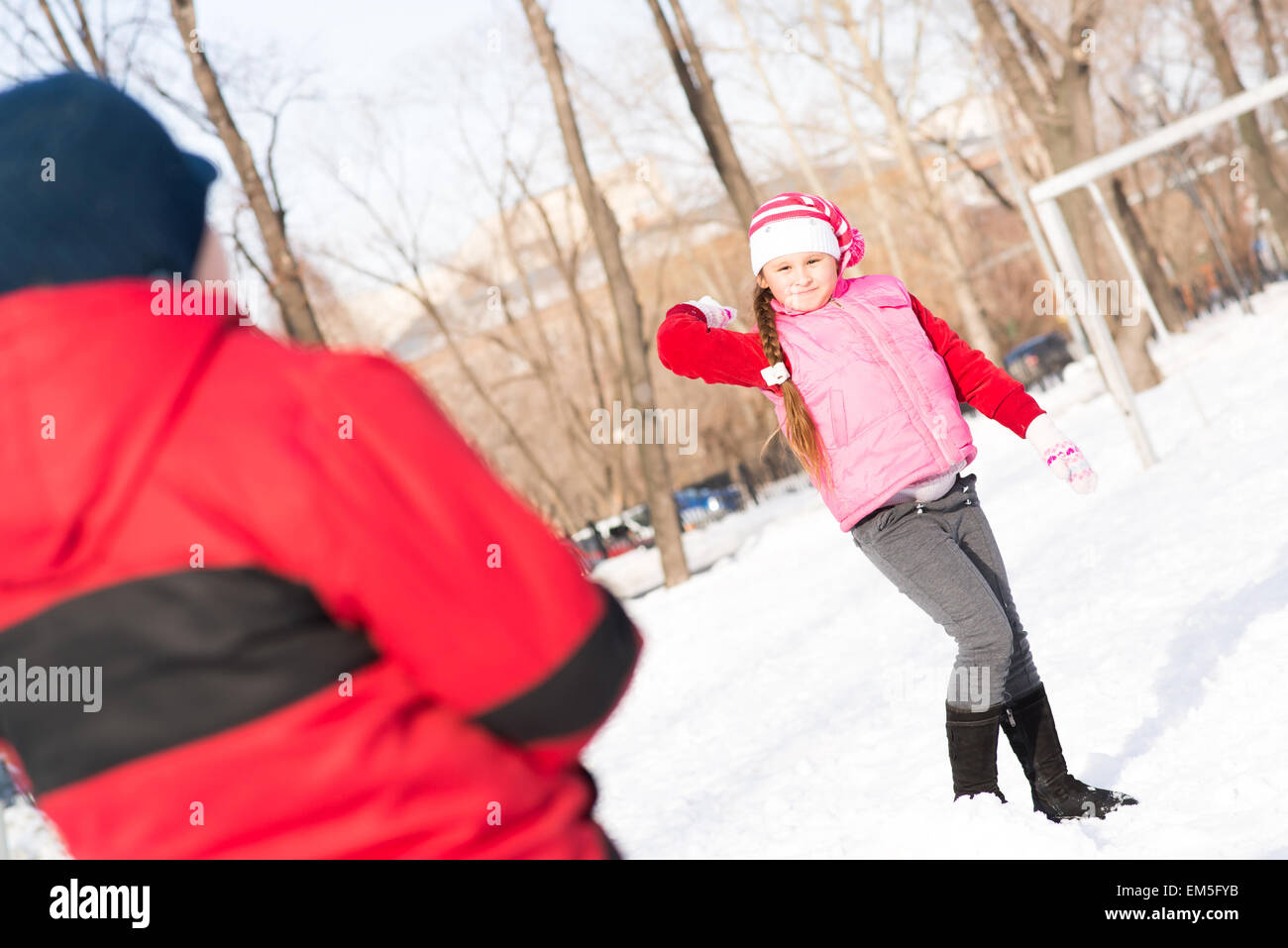 Children in Winter Park playing snowballs Stock Photo - Alamy