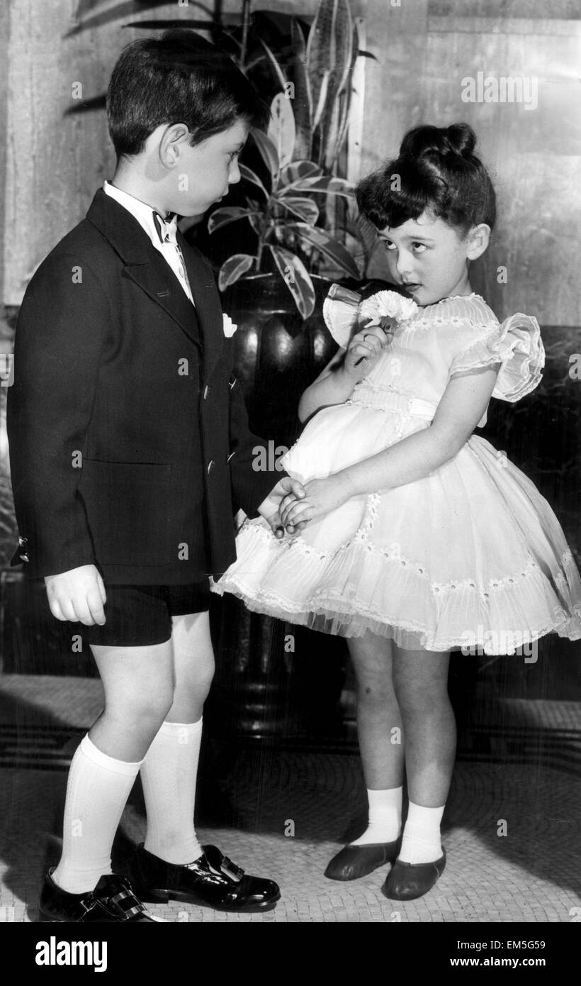 Young boy and girl holding hands. 2nd June 1958. Stock Photo
