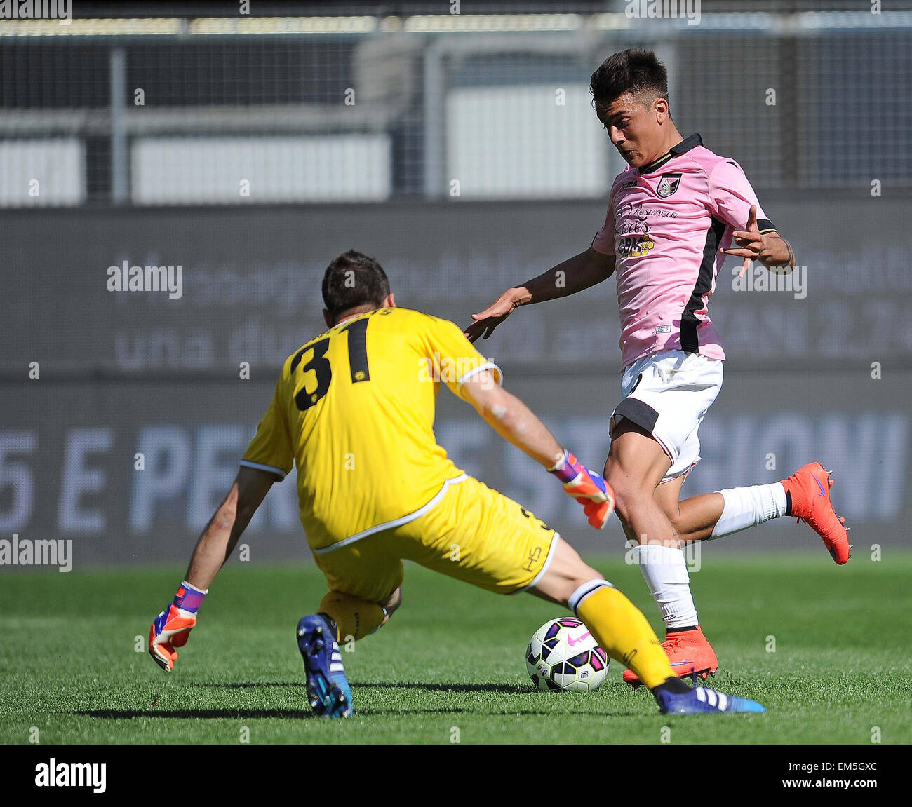 Palermo's forward Paulo Dybala past Udinese's goalkeeper Orestis Karnezis but missed the shot during the Italian Serie A Stock Photo