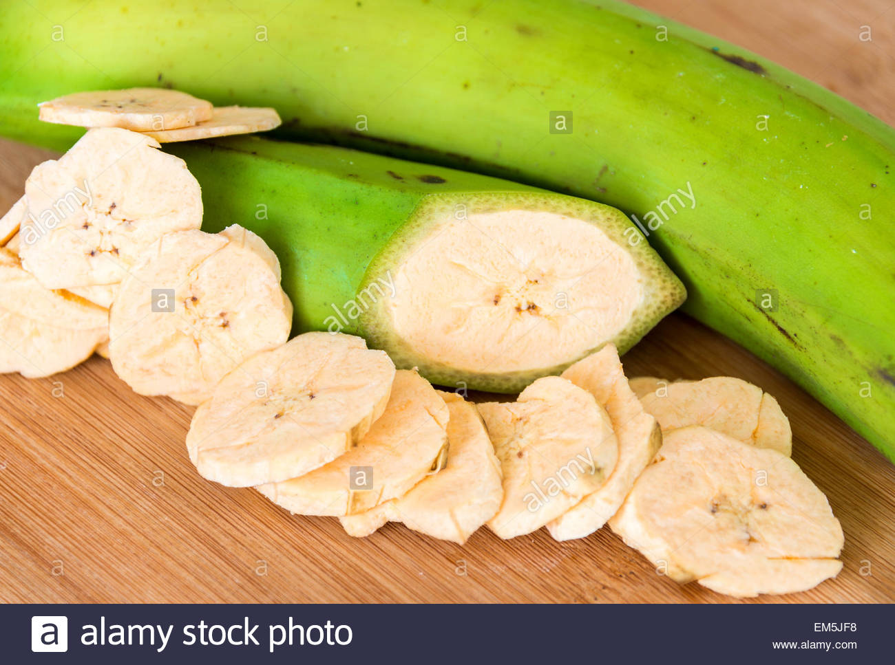 Cuban Cuisine Delicious green plantain bananas over wood cutting Stock