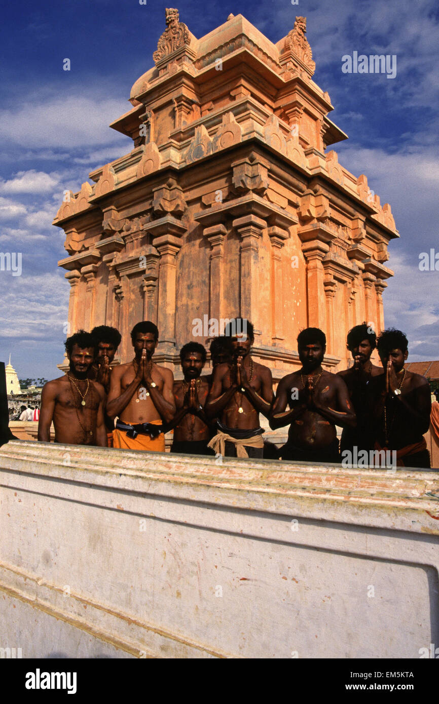A group of Hindu Pilgrims greeting with Namaste hand gesture at the temple complex dedicated to Goddess Kanyakumari (the virgin Goddess) at the shore of the town of Kanyakumari or Kanniyakumari also known as Cape Comorin in the state of Tamil Nadu South India Stock Photo