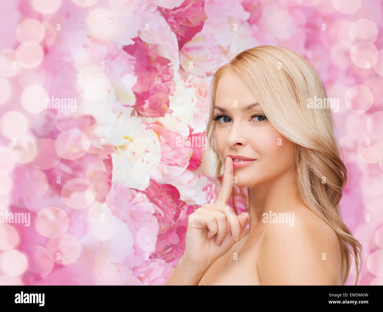 beautiful young woman pointing finger to lips Stock Photo - Alamy