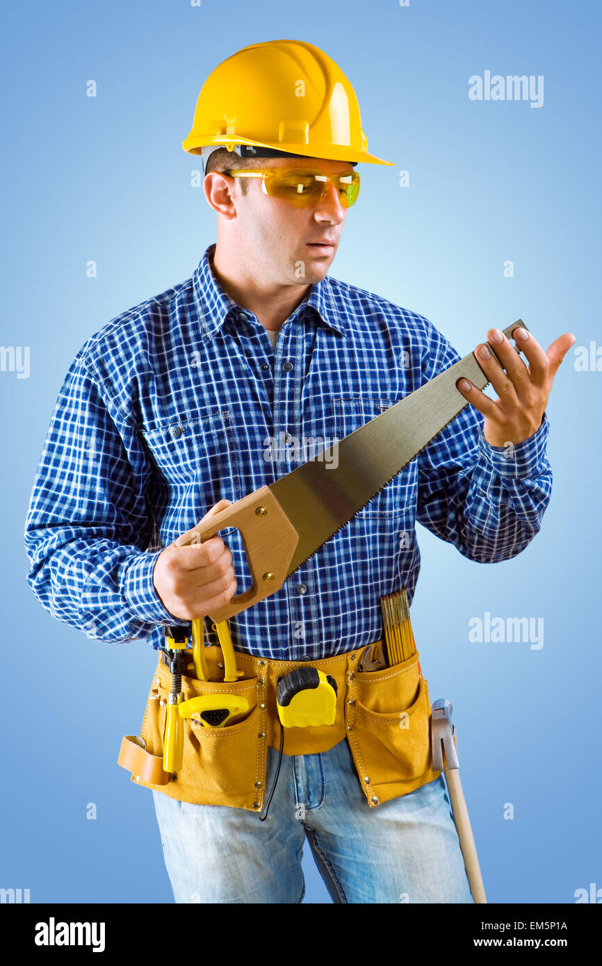 carpenter holding handsaw Stock Photo