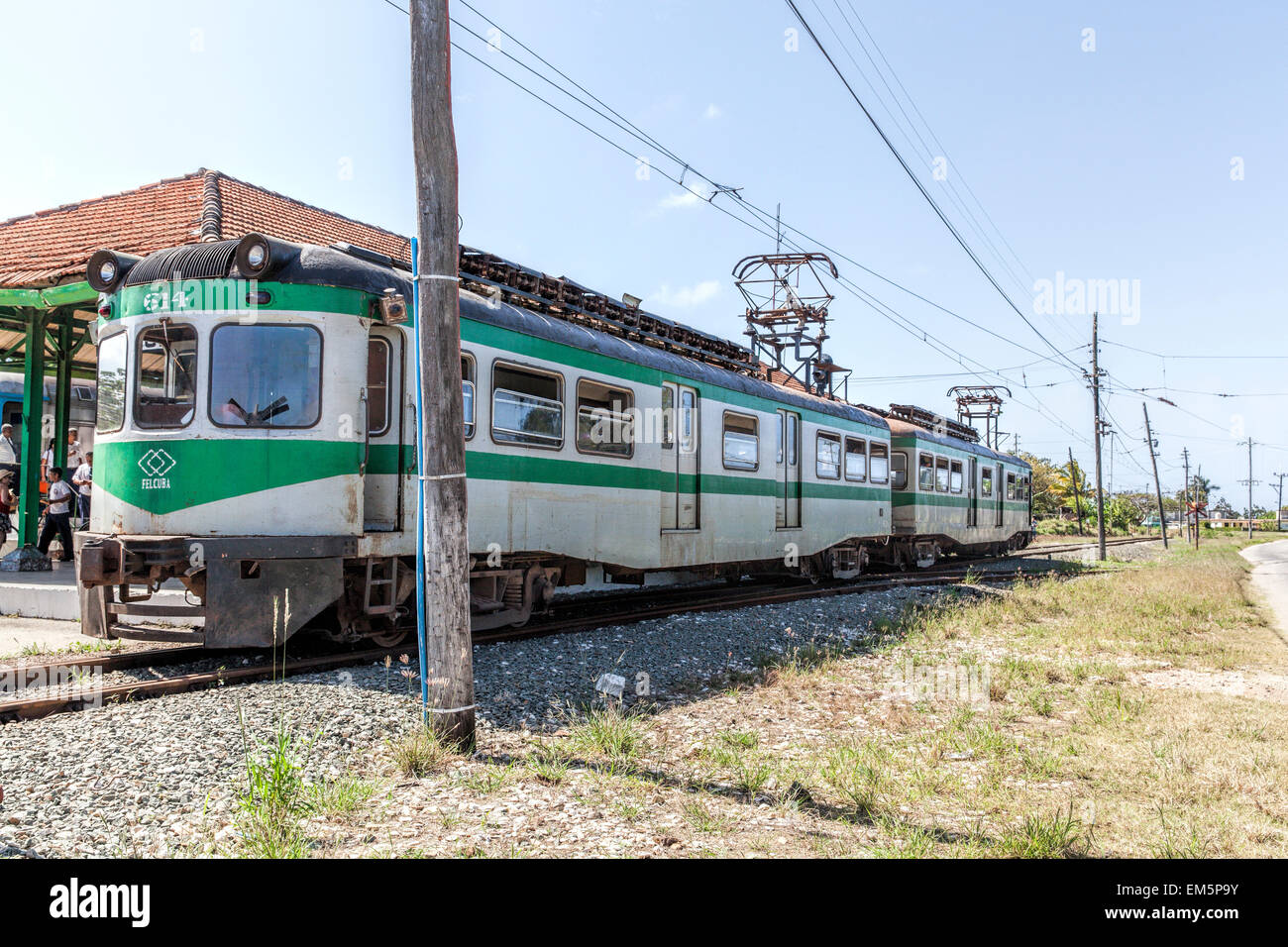 Working green and grey old electric gauge train bought from Spain on a railway track at a station in a remote part of Cuba Stock Photo