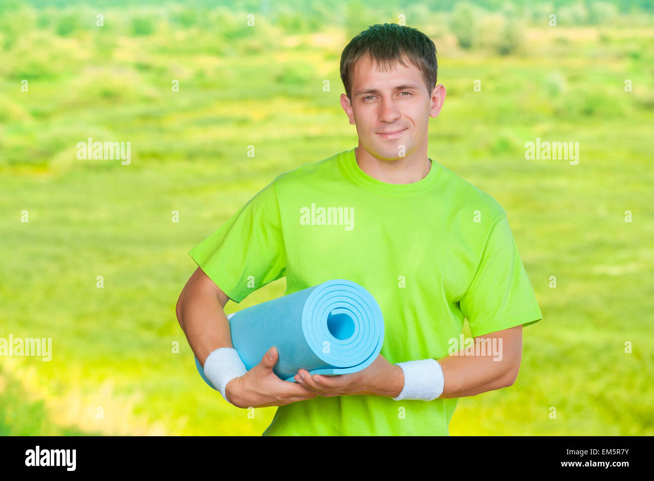 a sportsman holding yoga mat Stock Photo