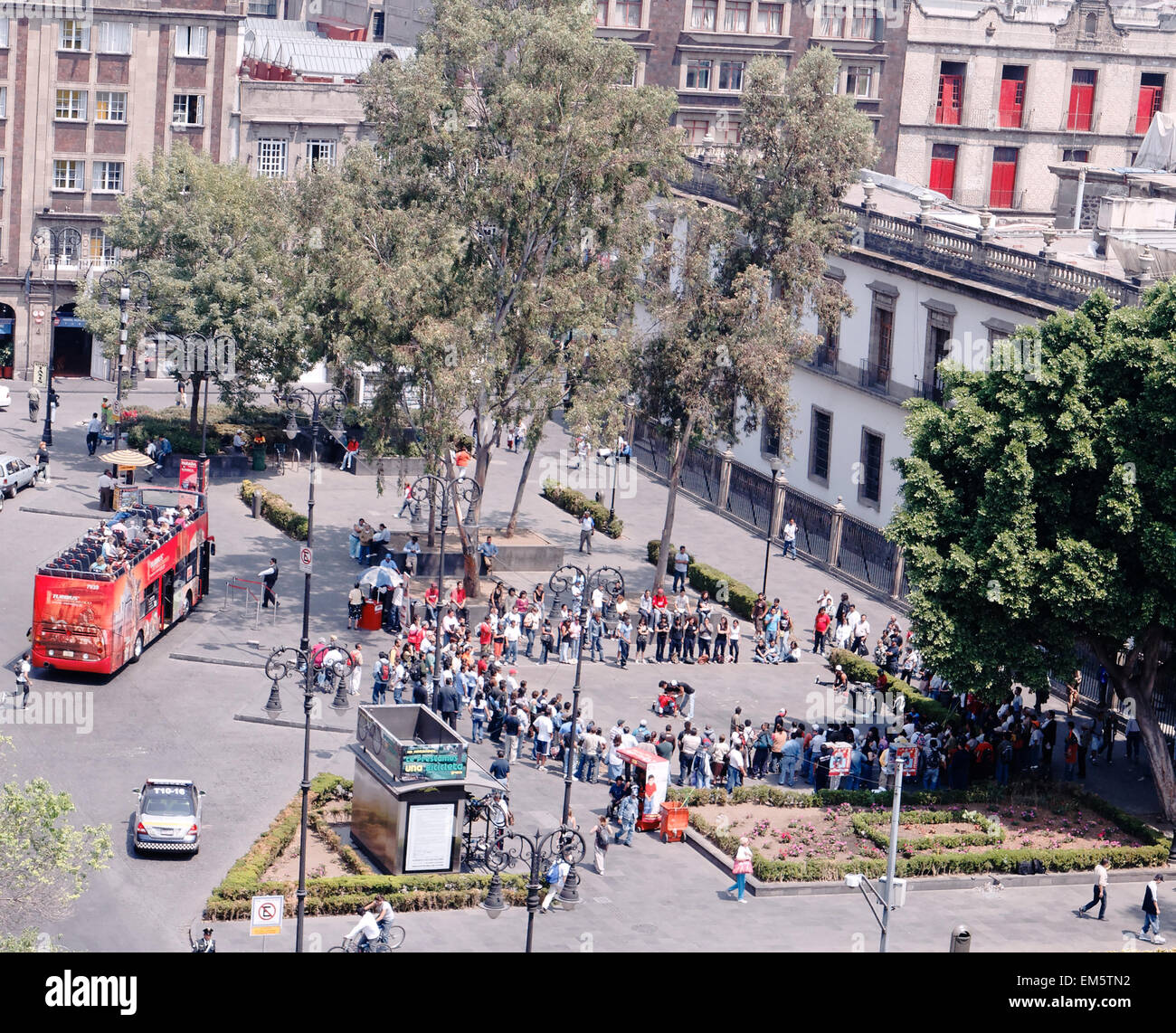 Tourists and tourist bus in the Zocalo, the main square in Mexico City, used as a location in Bond film Spectre Stock Photo