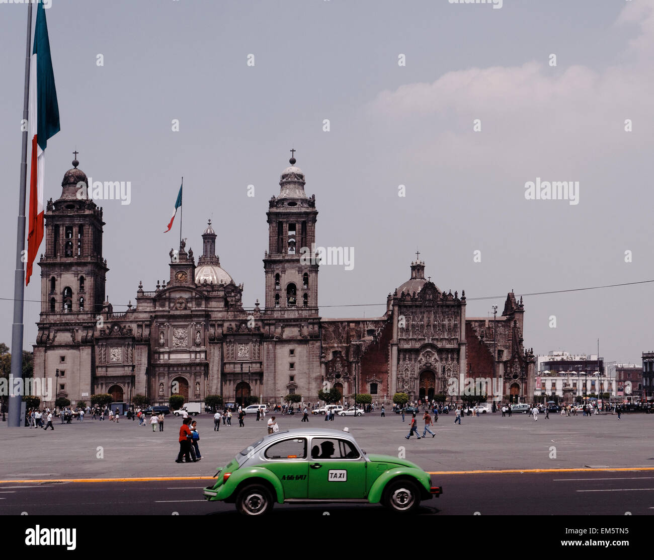 Green Volkswagen Beetle taxi and flying in the Zocalo, Mexico City, main square, Mexico Stock Photo