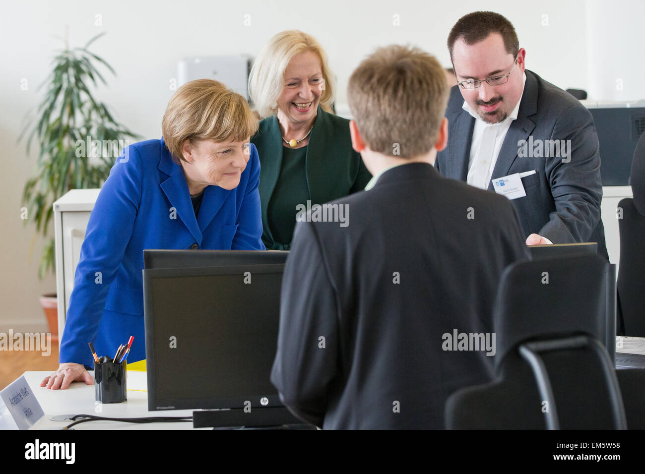 Nuremberg, Germany. 16th Apr, 2015. German Chancellor Angela Merkel (L) and the German Minister for Education and Research Johanna Wanka (both CDU), in conversation with employees during a visit to the IHK FOSA, (Foreign Skills Approval), the national competence centre of the German chambers of industry and commerce for the evaluation and recognition of foreign vocational qualifications, in Nuremberg, Germany, 16 April 2015. PHOTO: DANIEL KARMANN/dpa/Alamy Live News Stock Photo