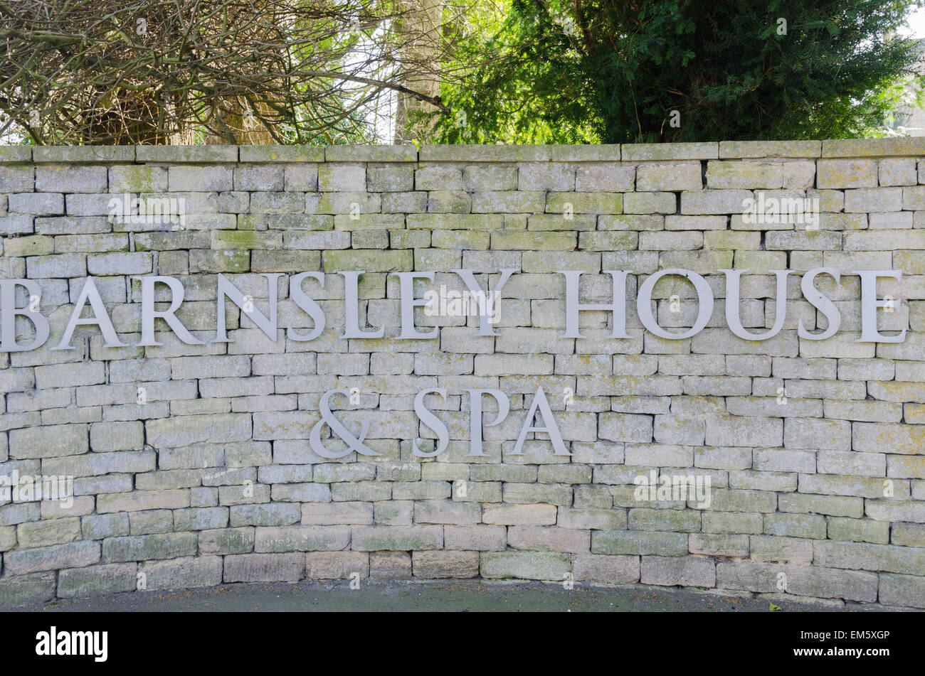 Sign on stone wall at the entrance to Barnsley House Hotel and Spa in the Cotswold village of Barnsley near Cirencester Stock Photo