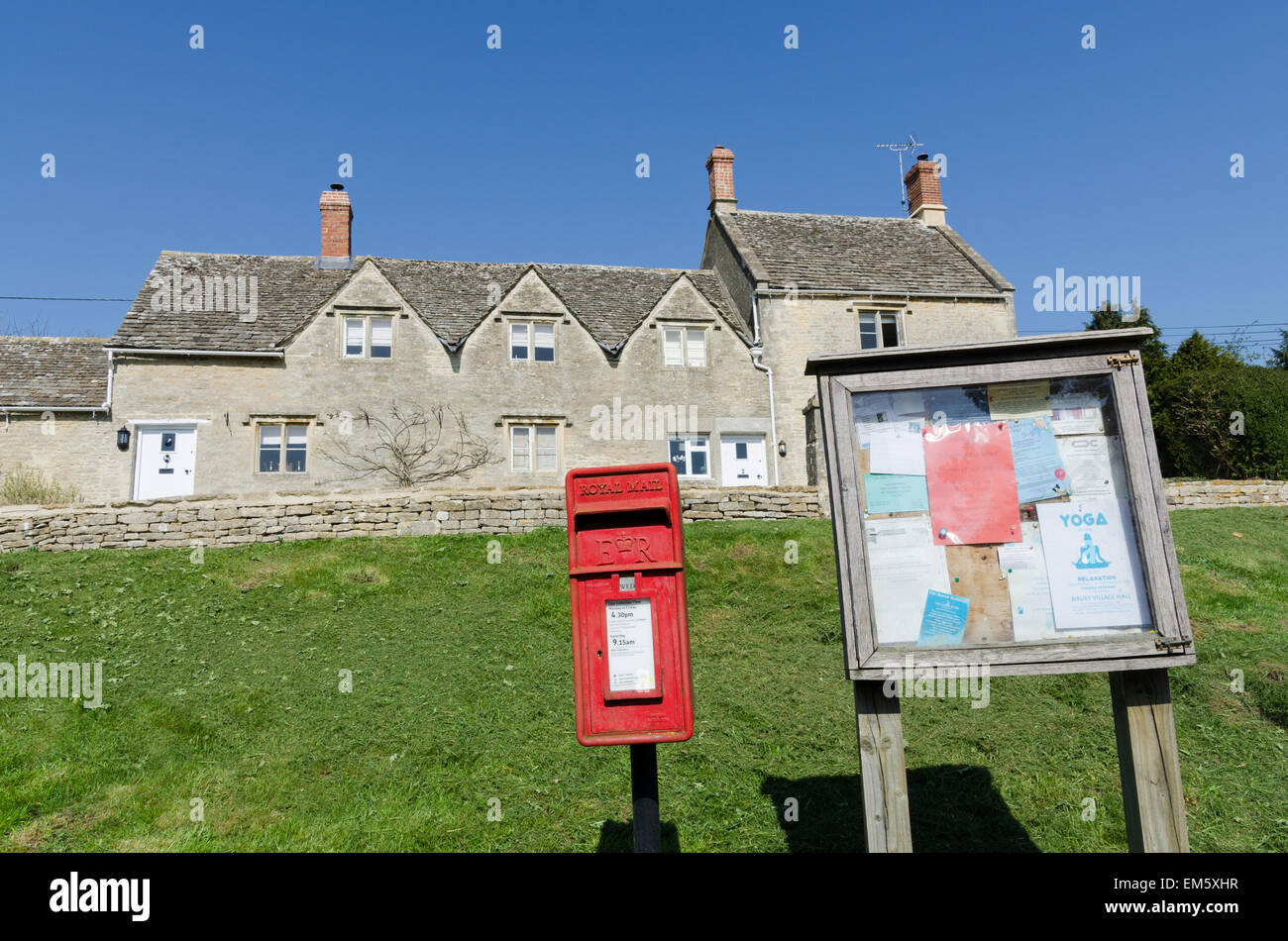 Post box and notice board on the village green in Bibury, near