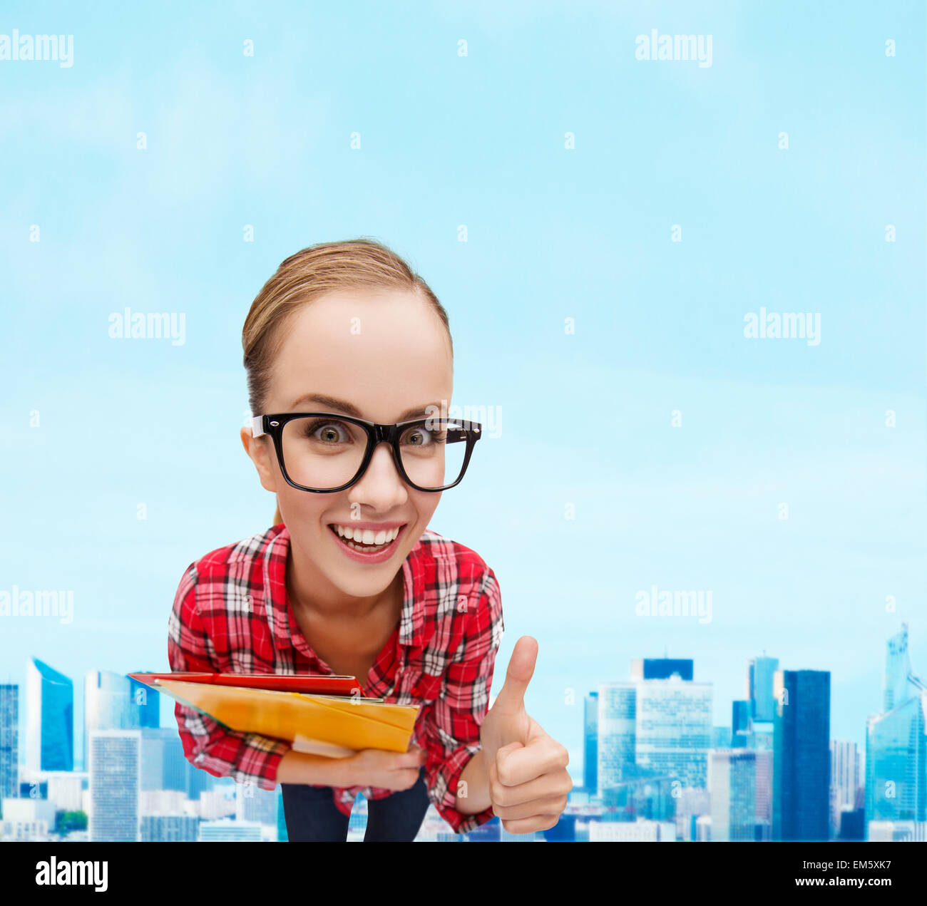 student in glasses with folders showing thumbs up Stock Photo - Alamy