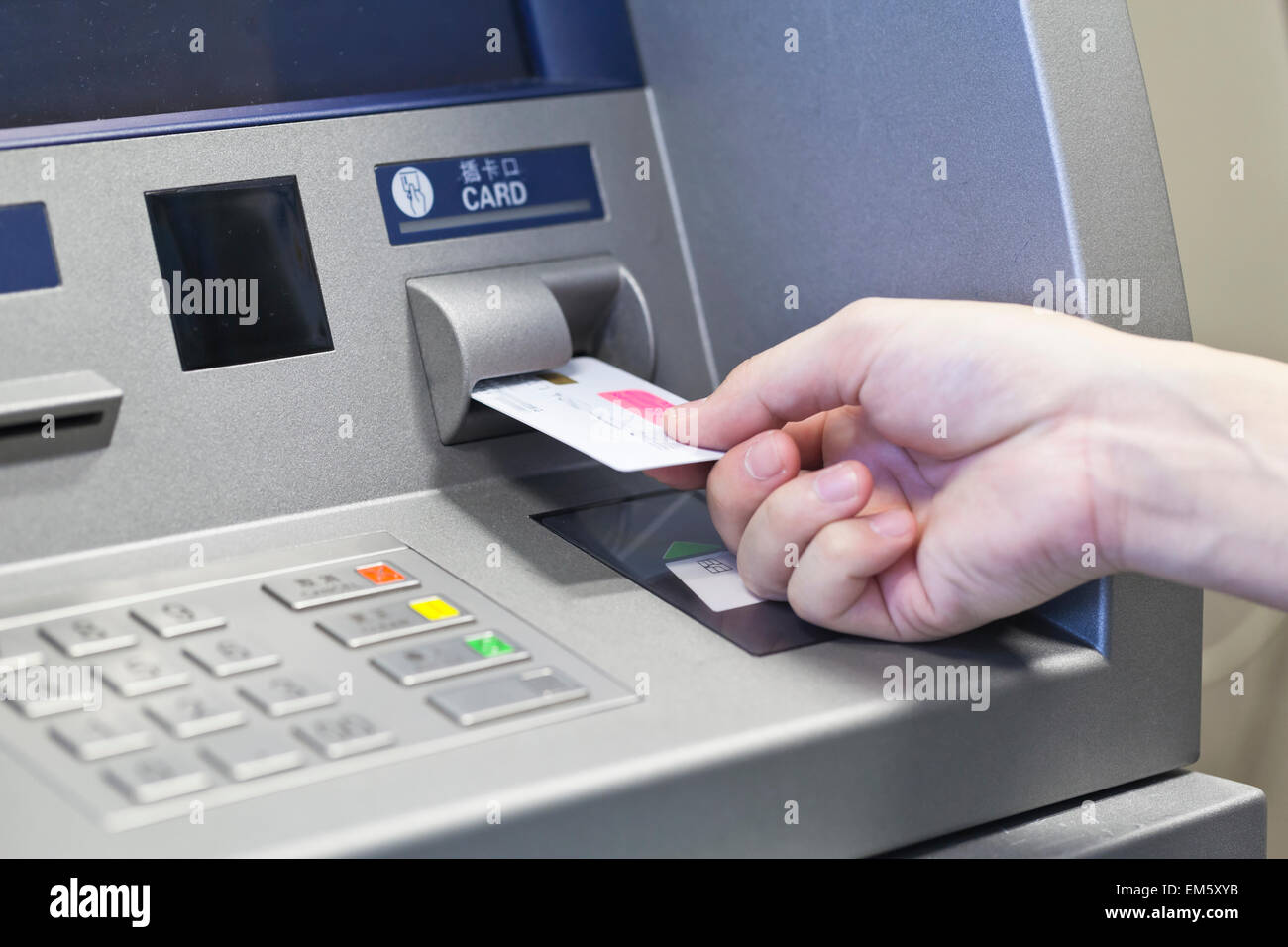 Hand taking money on ATM bank machine Stock Photo