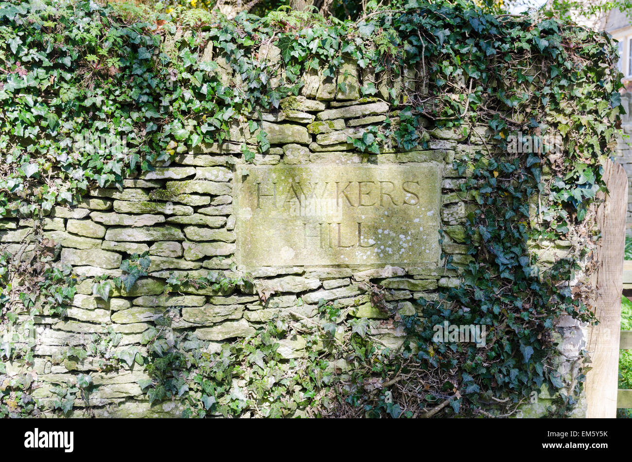 Stone street sign for Hawkers Hill embedded in stone wall in Bibury near Cirencester Stock Photo