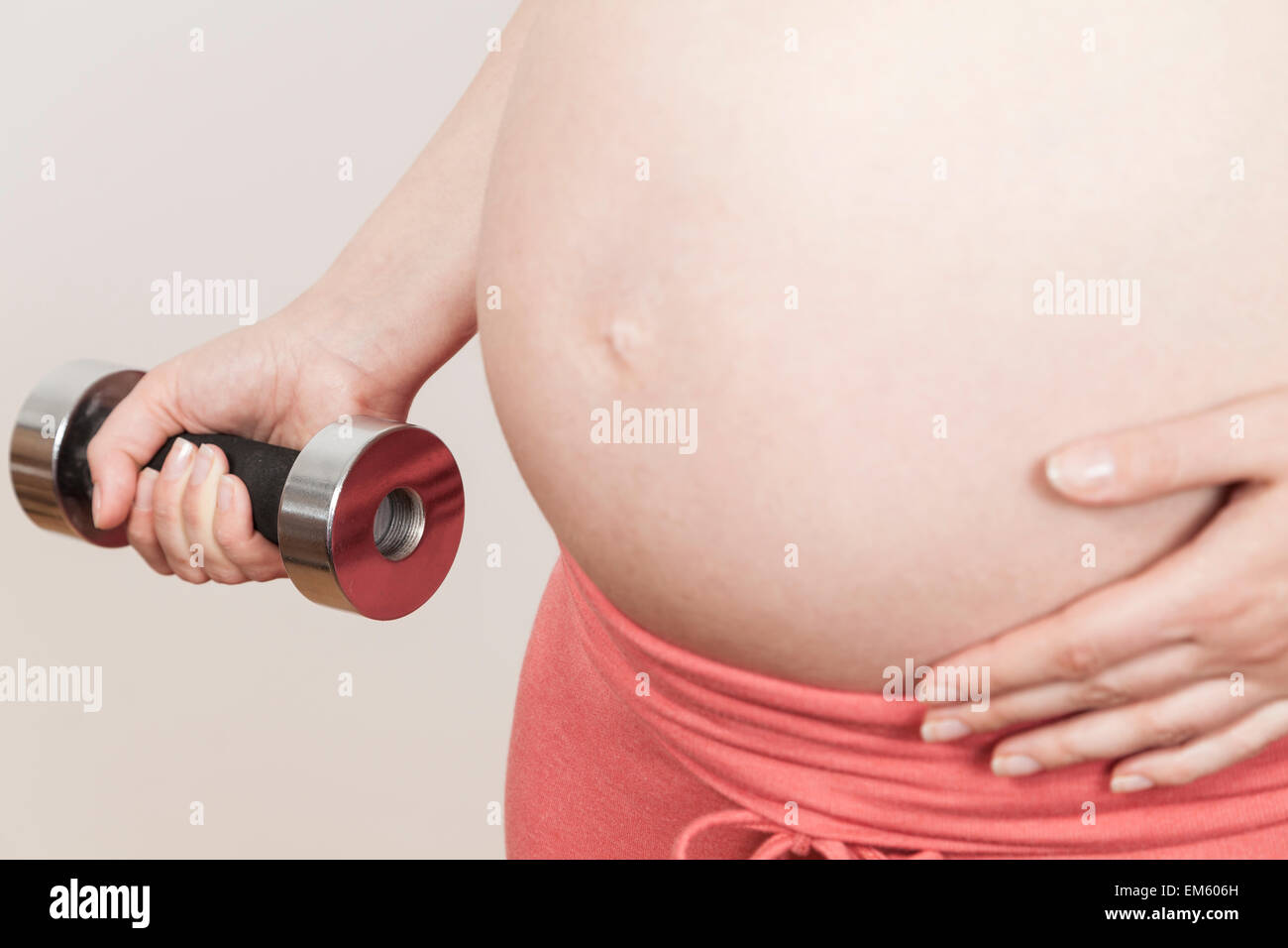 Picture of Pregnant holds dumbbell Stock Photo - Alamy