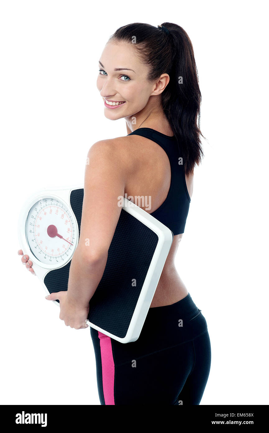 Female fitness trainer holding weighing machine Stock Photo Alamy
