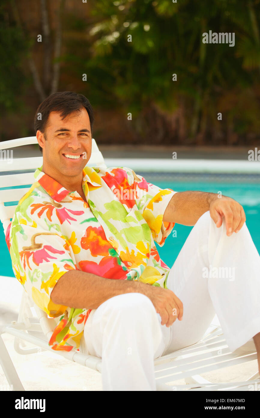 Hawaii, Local Man Sitting In Lawn Chair By The Pool Stock Photo Alamy