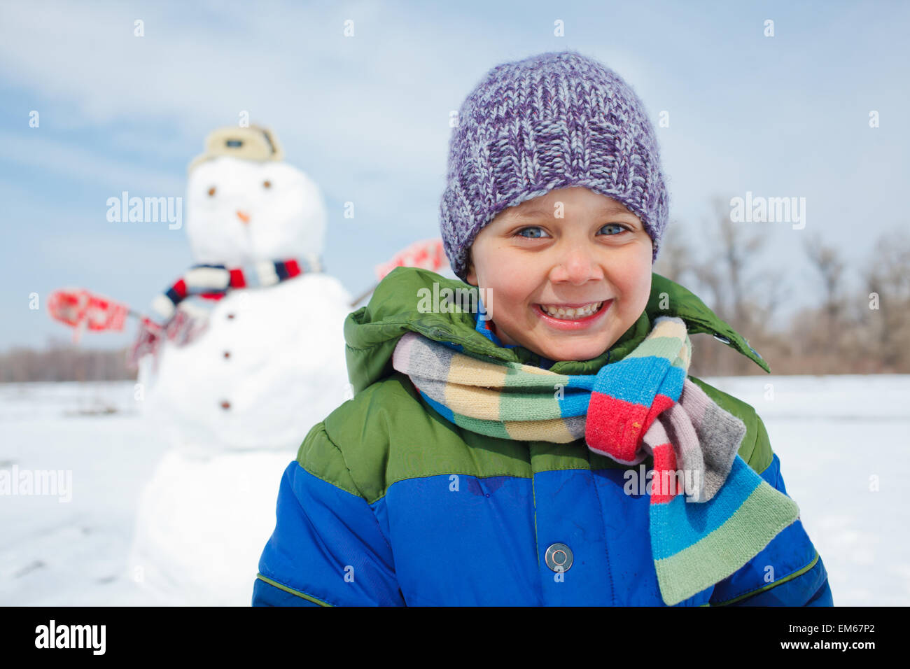 Boy makes a snowman Stock Photo