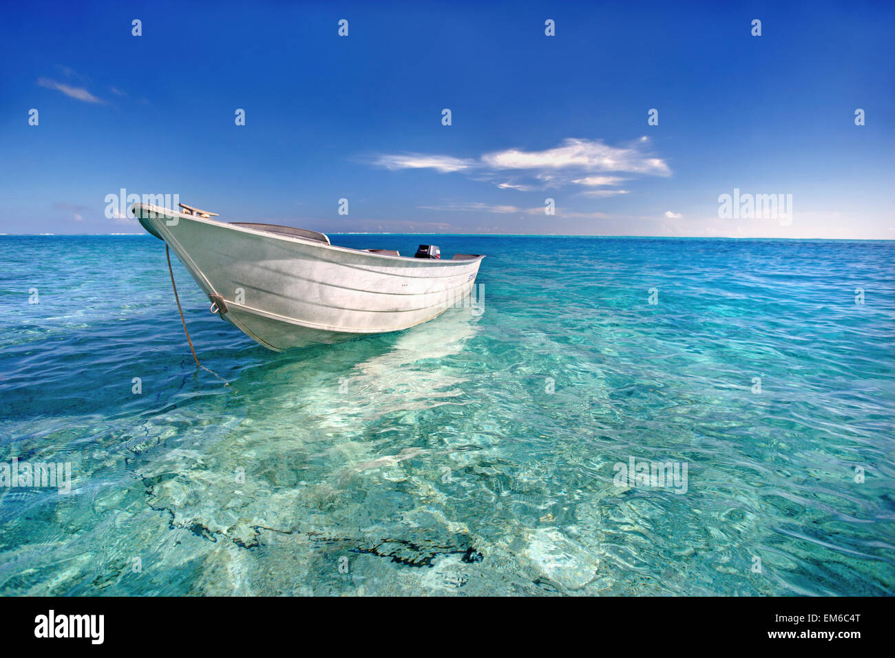 French Polynesia, Tahiti, Bora Bora, White Boat Floating On Turquoise Water. Stock Photo