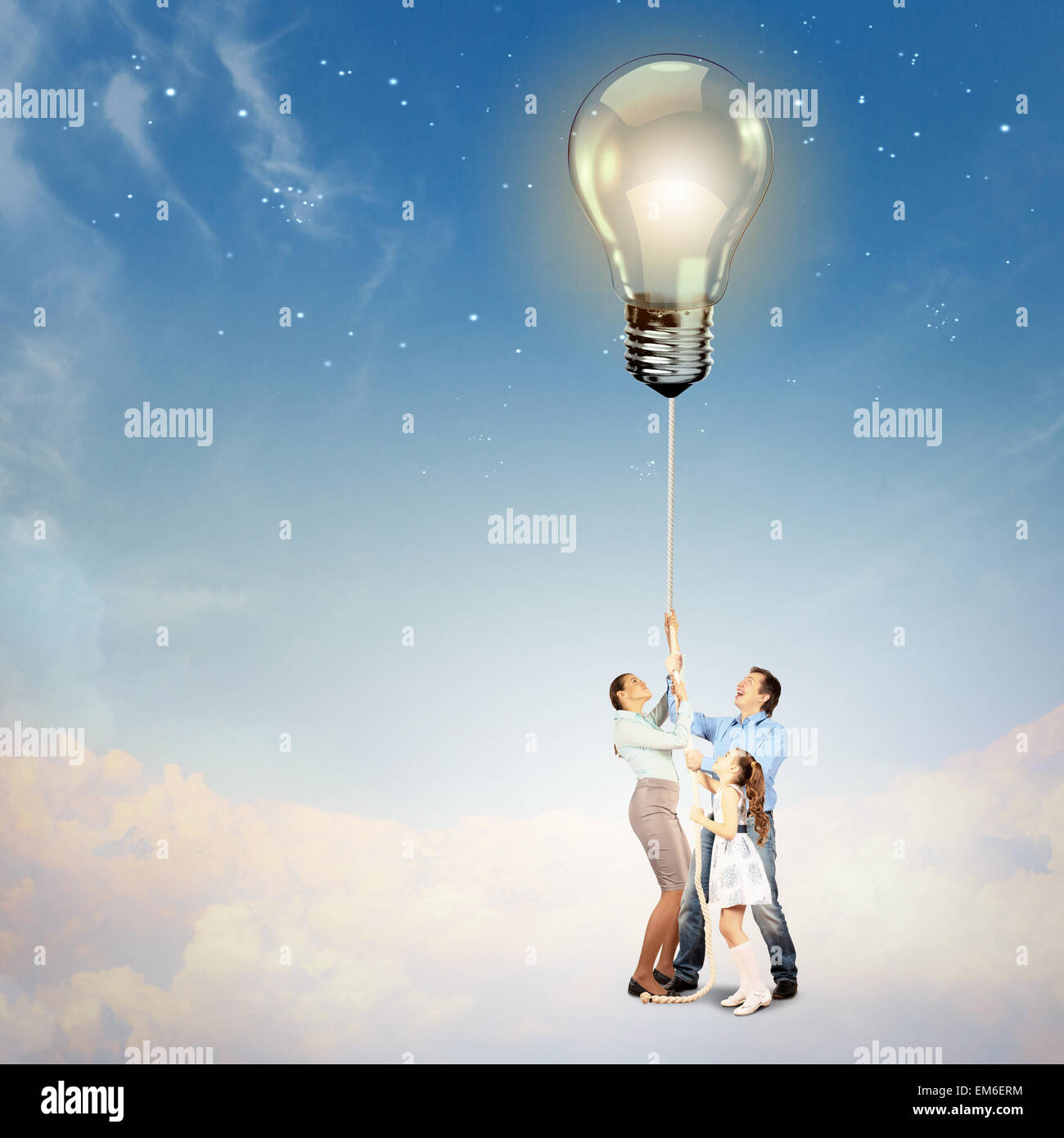 Family pulling rope with an electric bulb Stock Photo - Alamy