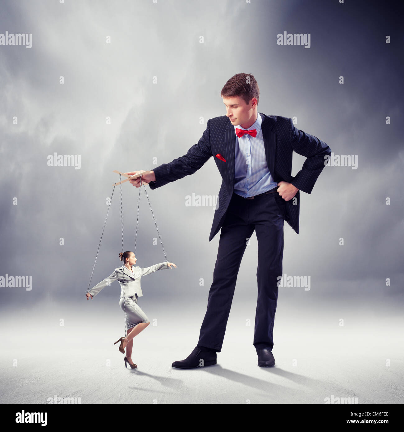 smiling female puppeteer holding male marionette isolated on grey Stock  Photo - Alamy