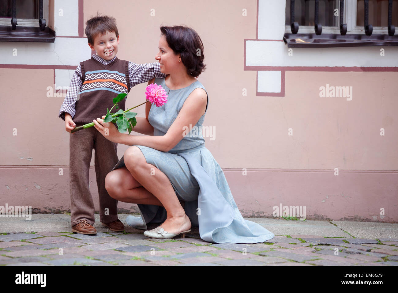 Little boy giving flower to his mom Stock Photo