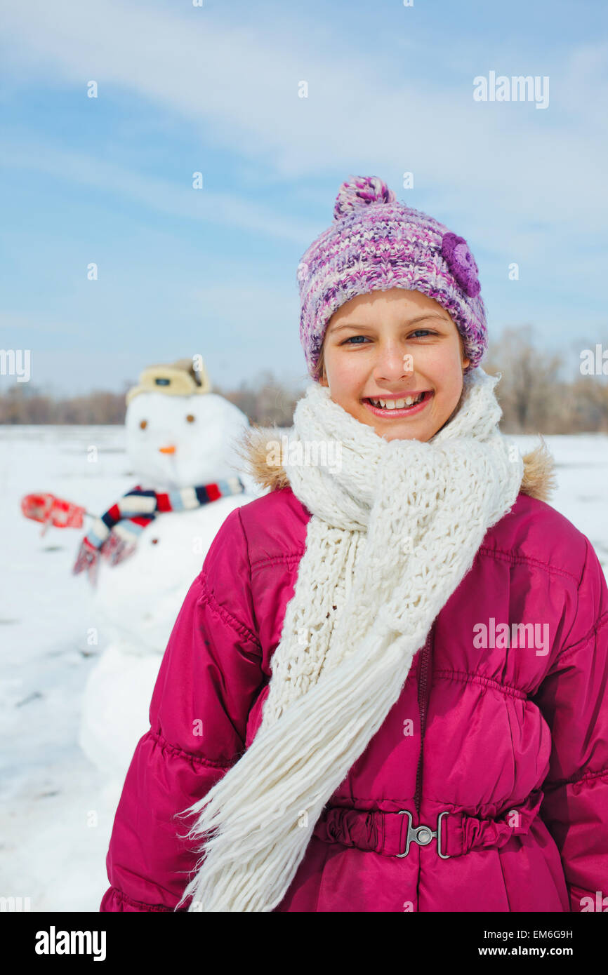 Girl with a snowman Stock Photo