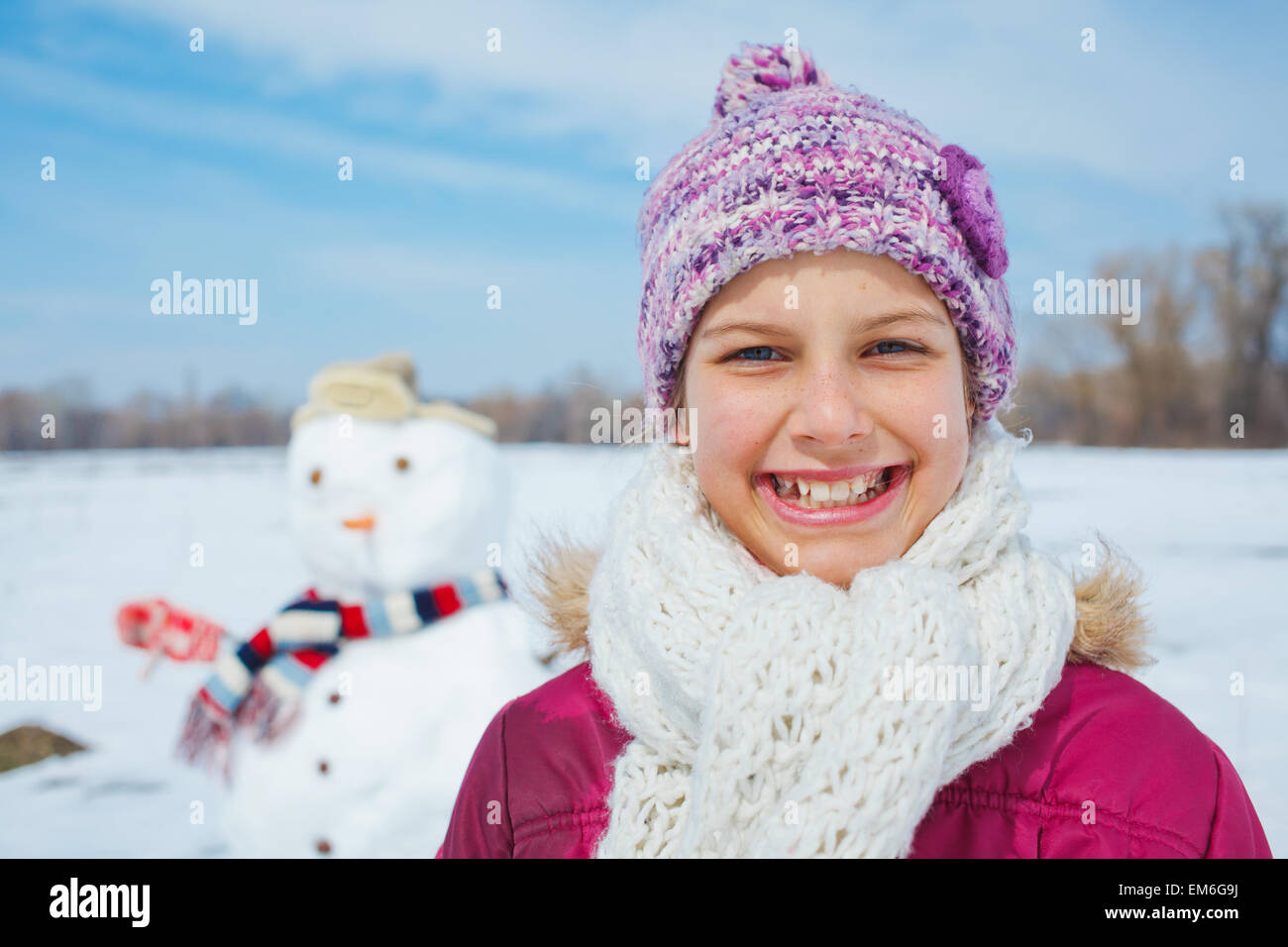 Girl with a snowman Stock Photo