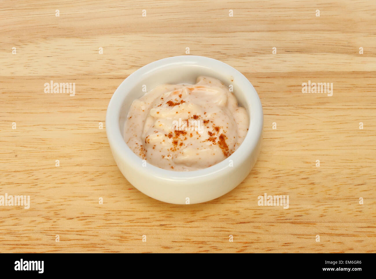 Seafood sauce with cayenne pepper in a ramekin on a wooden board Stock Photo